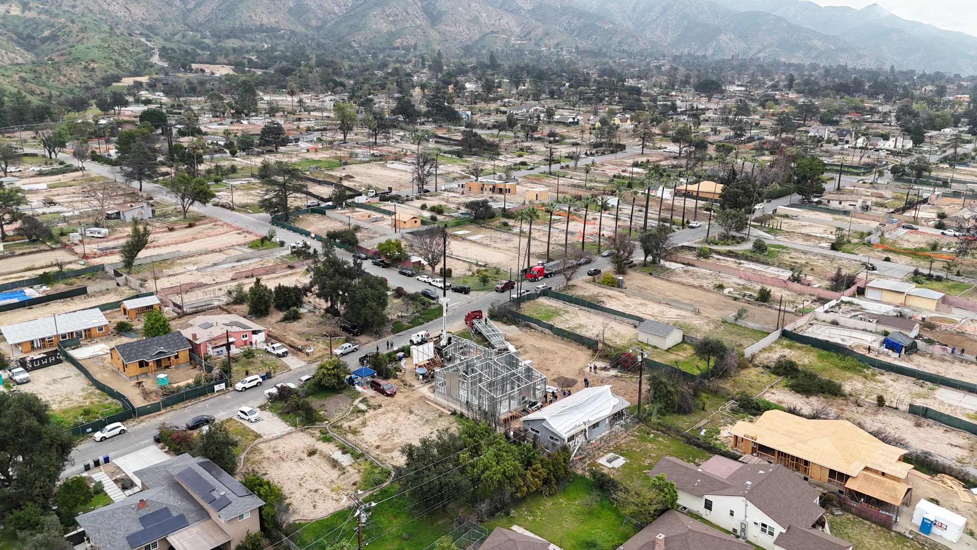 A new steel frame rising within a wildfire burn zone in Altadena